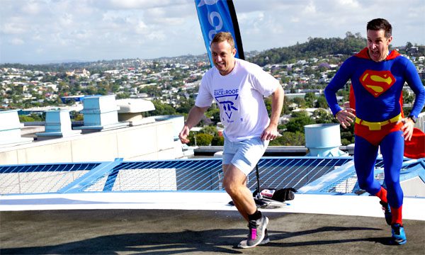 Health Minister Steven Miles and Adam Scott reach the helipad