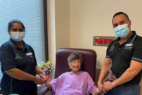 Two health professionals with elderly patient