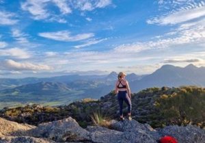 Person standing on top of a mountain