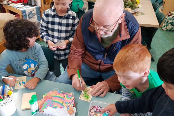 Grandfriends play with children at The Prince Charles Hospital Early Education Centre.