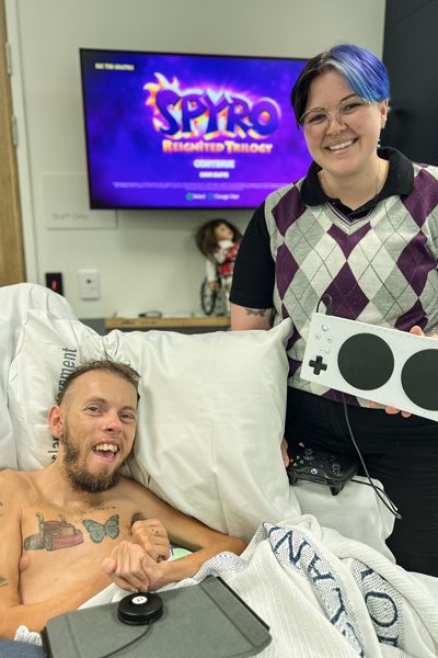 Patient Brodie, an avid gamer, with Rehab Engineering student Mikaela.