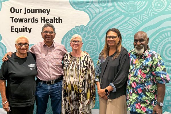 Metro North Chief Executive Jackie Hanson (centre) and Aboriginal and Torres Strait Islander Health Executive Director Sherry Holzapfel (second from right) with Metro North Health staff and Elders connecting at a health equity showcase.