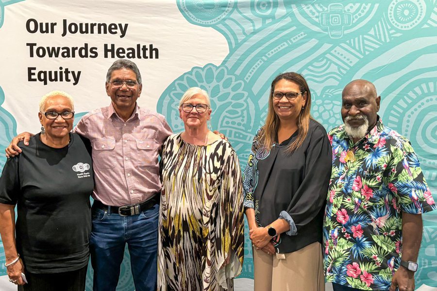 Metro North Chief Executive Jackie Hanson (centre) and Aboriginal and Torres Strait Islander Health Executive Director Sherry Holzapfel (second from right) with Metro North Health staff and Elders connecting at a health equity showcase.