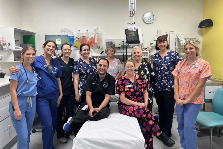 Paediatric clinicians at The Prince Charles Hospital are a key metropolitan site in the Mini Magic Mirror study, which is aiming to reduce extravasation injuries in children. Back row — left to right: Resident (Emergency) Dr Katie McDowell, Resident (Emergency) Dr Samar Al Shama, Clinical Nurse Emergency and Research and Project Manager MiniMAGIC MIRRORS Louise Mills, Nurse Practitioner Andrea Hetherington, Nurse Practitioner Julie Craig, Paediatric Emergency Consultant and Director of Research TPCH ED (Adults and Paediatric) Dr Faye Jordan, Registered Nurse Jenny Peak and Resident (Emergency) Dr Karen Bogle. Front row — seated — left to right: Paediatric Emergency Consultant Dr Mina Mina and Paediatric Emergency Department Nurse Unit Manager Leisa Bauer.