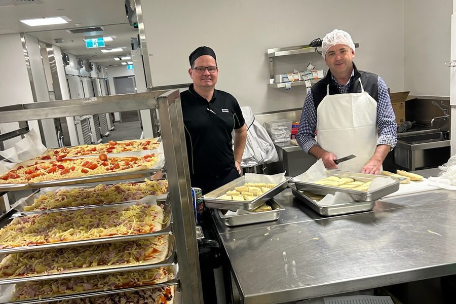 STARS Food Service Team preparing pizza for the State of Origin pizza night.