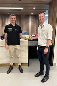 Nathan Alexander receiving prize from Rehabilitation Engineer, Oli Mason