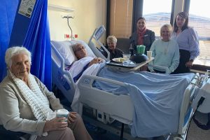 Karen Leighton and Tami Photinos with patient Garry Askew and family