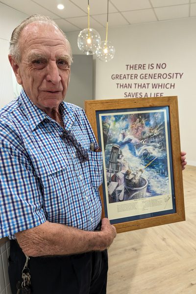 Artist Donald James Waters with his artwork to be auctioned.