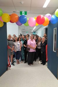 Rose Cooper standing with Intensive Care Unit staff