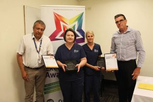 Samantha Wacker and Heidi Virtanen holding the Values in Action Dual Winner award