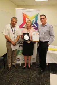 Jo Barron holding the Excellence in Performance Dual Winner award