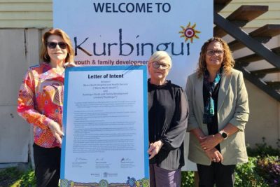 Glenda Jones-Terare, Chief Executive Officer and Sherry Holzapfel and holding a poster size image of the Letter of Intent