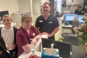 Caboolture Satellite Hospital staff gathered around a computer workstation