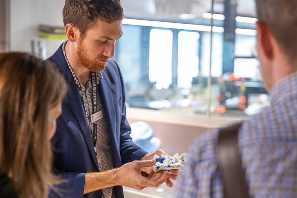 three people looking at 3D printed tumor model.