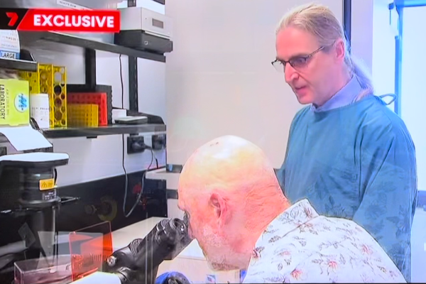 two men looking at microscope