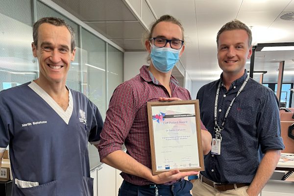 3 men with award