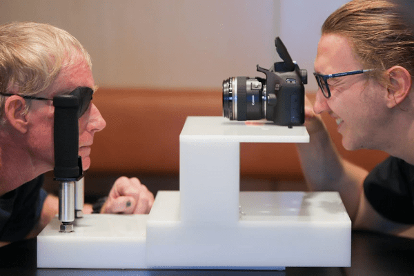 man taking photo of patient eye