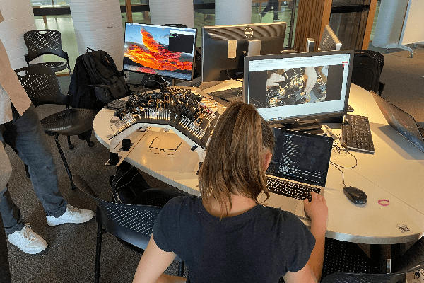 student at computer looking at code