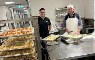 STARS Food Service Team preparing pizza for the State of Origin pizza night.