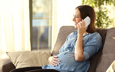 Pregnant woman talking on phone
