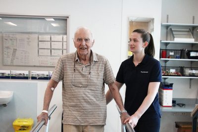 Man using hand rails with physio