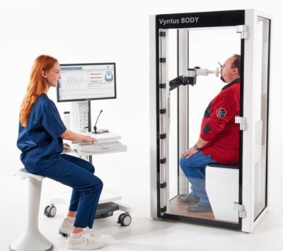 Patient in a respiratory testing machine with a clinician monitoring